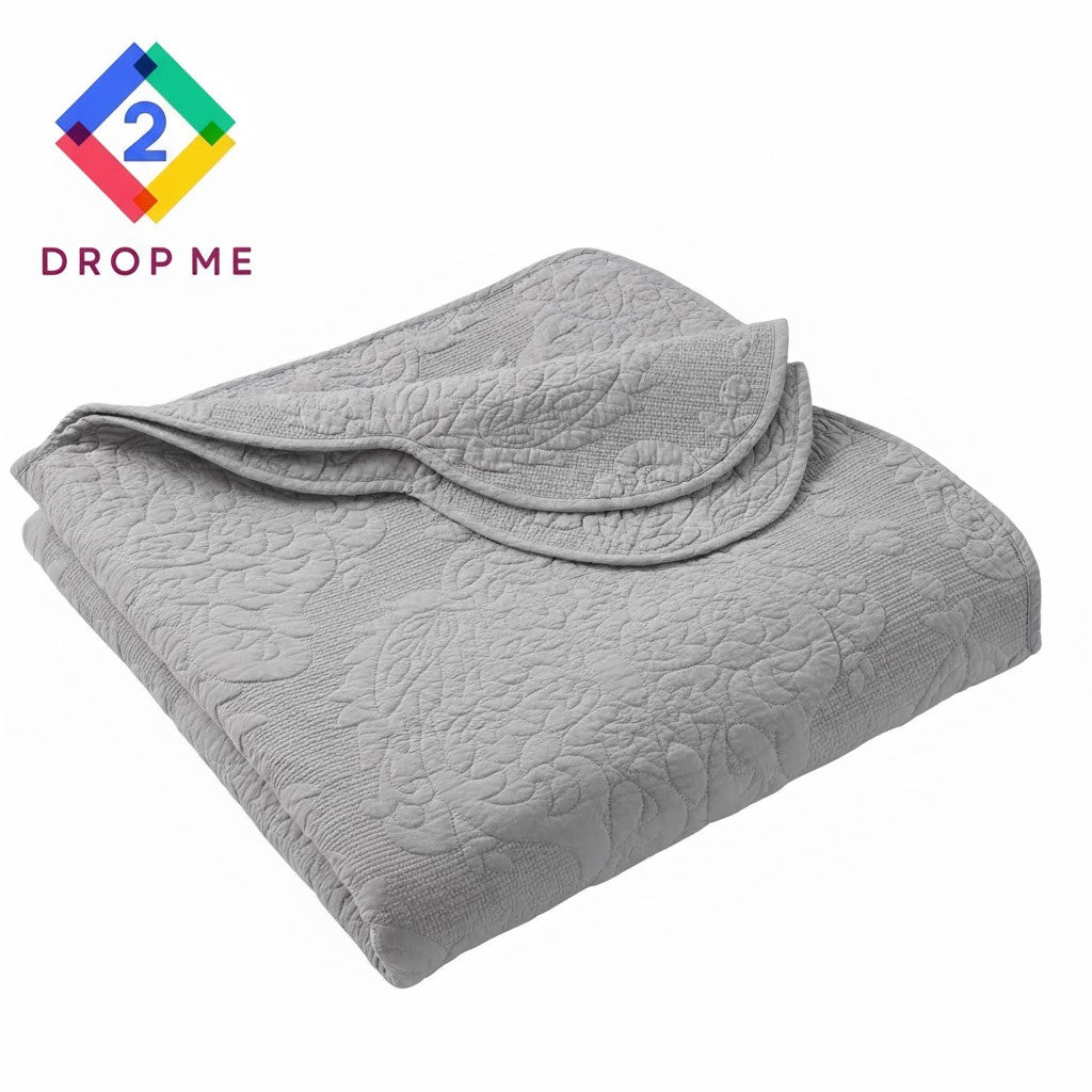 Folded gray paisley cotton quilt showing scalloped trim – lightweight, soft, and machine washable 🧺