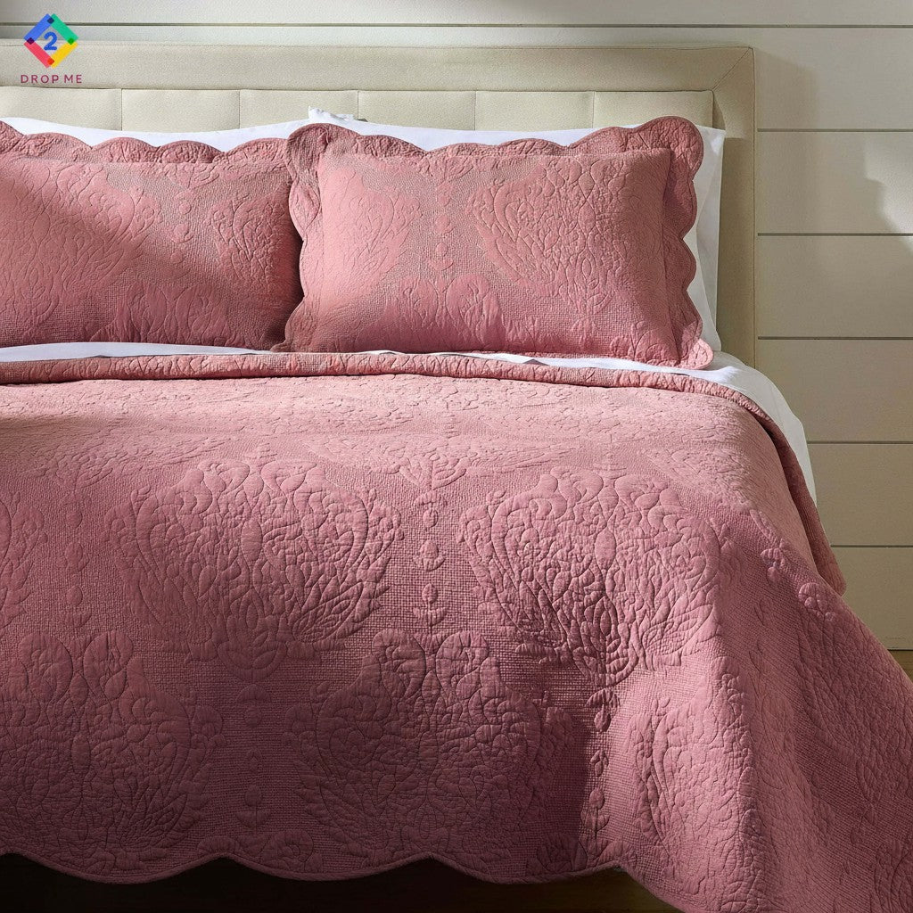 Rose pink paisley embroidered cotton quilt on bed with scalloped edges – romantic and cozy bedding for all seasons