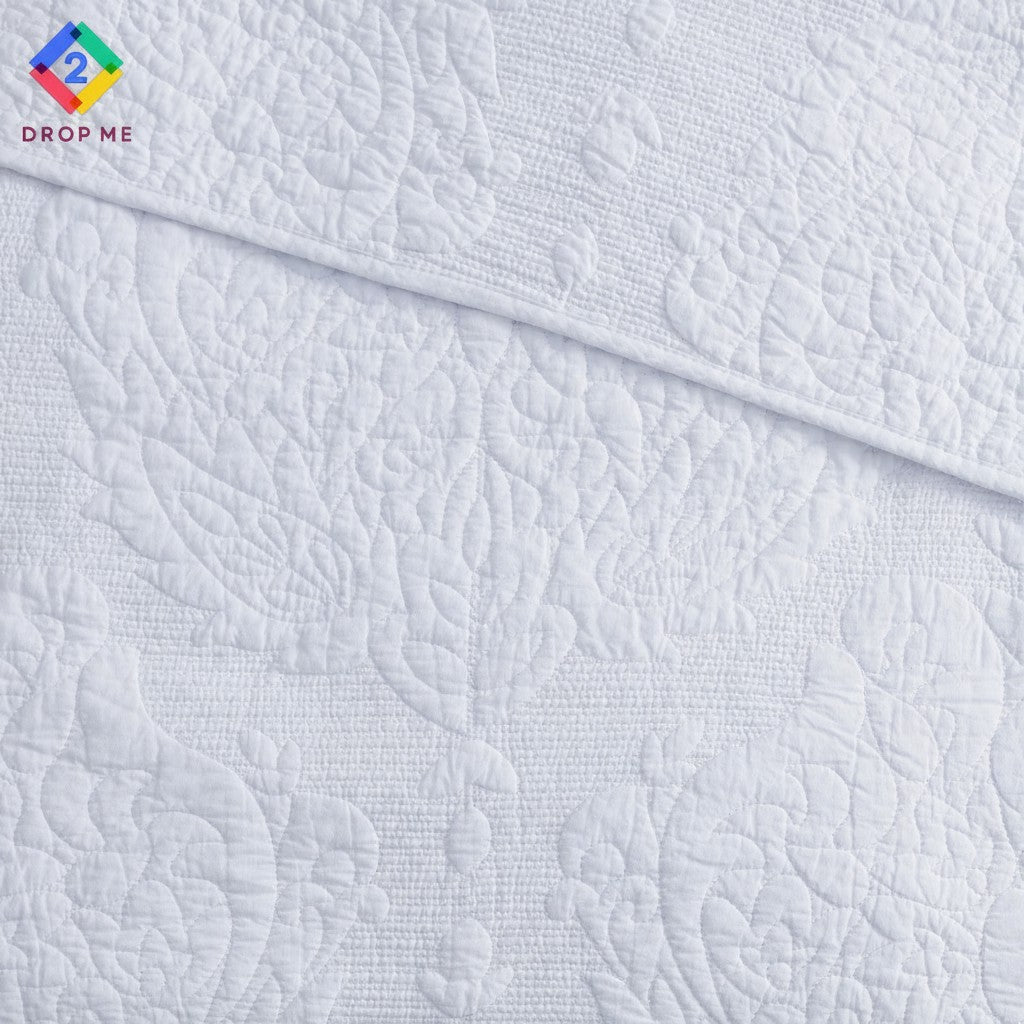 Close-up of paisley embroidery on white cotton quilt by Better Homes & Gardens – detailed stitching and soft woven texture 🪶
