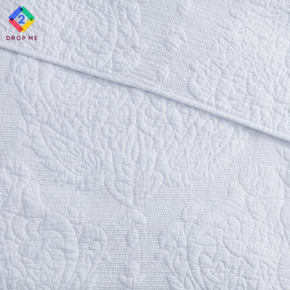 Close-up of paisley embroidery on white cotton quilt by Better Homes & Gardens – detailed stitching and soft woven texture 🪶